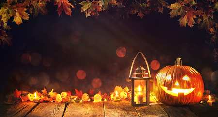 Halloween pumpkin with lantern on old wooden