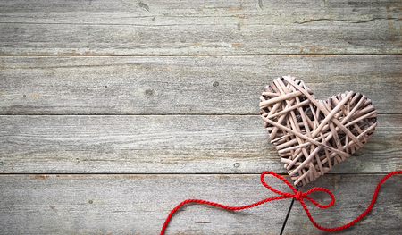 Valentines day background with handmade heart over wooden tableの写真素材