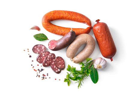 Assortment of german homemade sausage specialties: hard cured salami, liver sausage (Leberwurst), blood sausage (Blutwurst) and salami isolated on whiteの写真素材