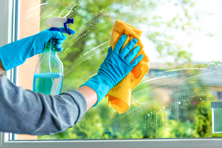 Cleaning window pane with detergent, spring cleaning conceptの写真素材