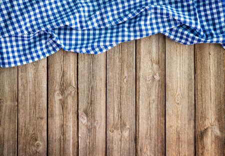 Oktoberfest background frame with bavarian white and blue tablecloth on rustic wooden boardの写真素材