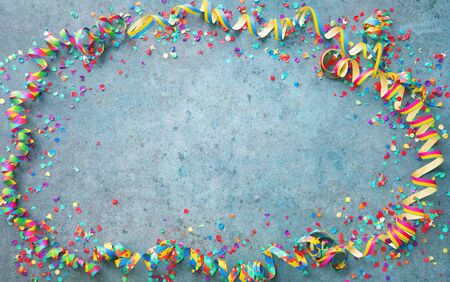 Festive carnival or birthday party background with colorful streamers and confettiの写真素材
