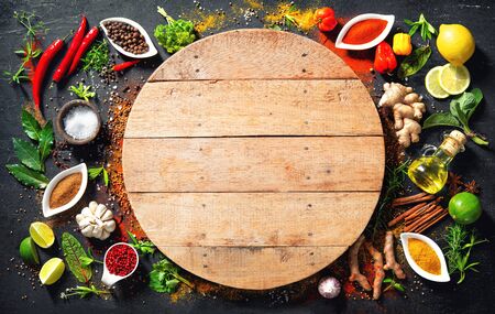 Colourful  of various herbs and spices in bowls for cooking with copy space for your textの写真素材