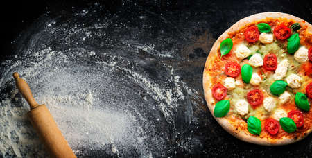 Crispy italian pizza with ricotta, tomatoes and basil.の写真素材