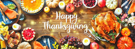 Festive turkey dinner table. Thanksgiving celebration traditional dinner concept with Happy Thanksgiving textの写真素材
