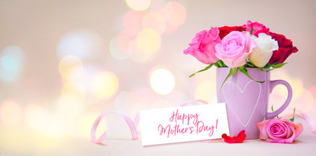 Mug with a heart, bouquet of roses and a tag with a text Happy Mothers Dayの写真素材