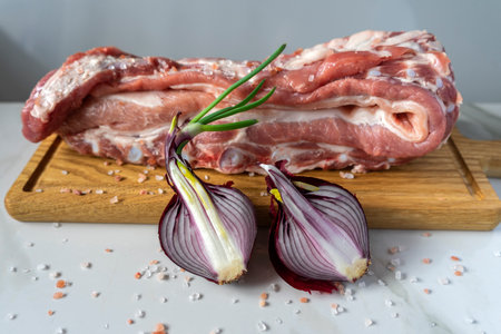 pig meat lying on a cutting board ready for further cookingの写真素材