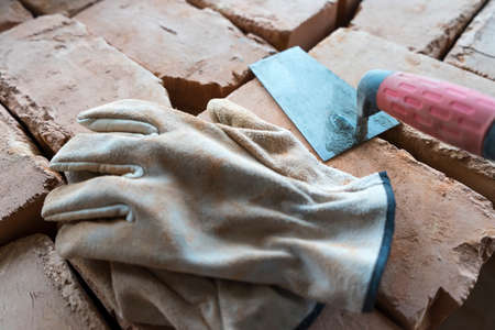 Brickwork of brick, folded in a certain way and fixed with mortar. industrial brick placing brick on cement in the construction of external walls, industry detailsの写真素材