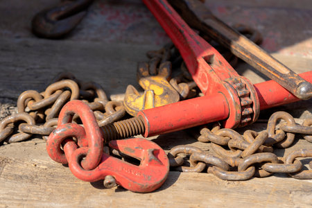 Crane hook, on which chains with hooks and fastening elements are attached. Lifting mechanism in production and warehouse close-up.の写真素材