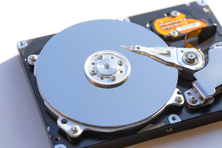 Disassembled hard drive from the computer, hdd with mirror effect. Opened hard drive from the computer hdd with mirror effects. Part of computer pc, laptopの写真素材