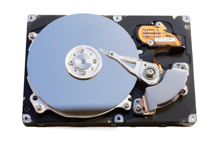 Disassembled hard drive from the computer, hdd with mirror effect. Opened hard drive from the computer hdd with mirror effects. Part of computer pc, laptopの写真素材