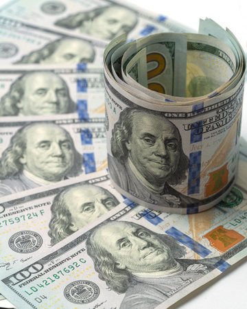 Money, US dollar bills background. Paper money is scattered on the table with silver coins. Photo for finance and economics concepts.の写真素材