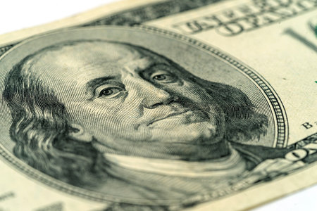 Money, US dollar bills background. Paper money is scattered on the table with silver coins. Photo...