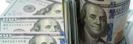 Money, US dollar bills background. Paper money is scattered on the table with silver coins. Photo...