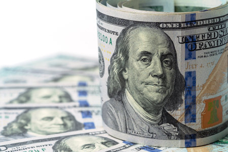 Money, US dollar bills background. Paper money is scattered on the table with silver coins. Photo for finance and economics concepts.の写真素材