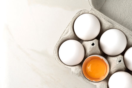 Close-up of lots of raw whole white chicken eggs for cooking fresh homemade food.