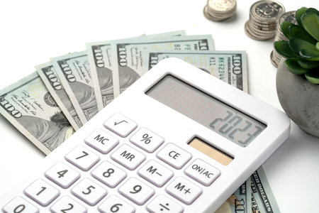 A white calculator with 2023 on the screen. A concept for recording income, expenses and controlling finances.の写真素材