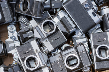 old-fashioned retro camera lying in a heap with other old camera gates at a flea marketの写真素材