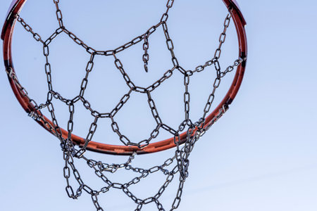 Basketball hoop on a sports field against a blue skyの写真素材
