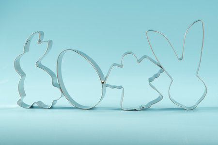 easter bunny on blue background. Happy Easter Day concept. Minimal Easter concept. Space for text. Easter Cookie Cutter on baking background.の写真素材
