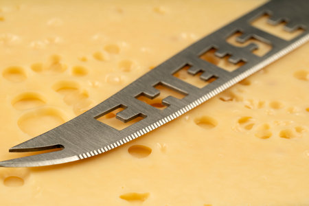 Knife with the inscription Cheese. Texture of Radomer cheese with close-up on a black backgroundの写真素材