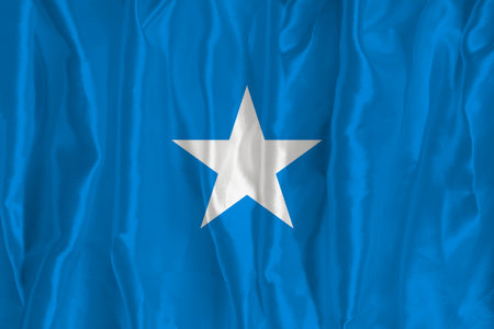 The flag of Somalia on a silk background is a great national symbol. Texture of fabrics The official state symbol of the countryの写真素材