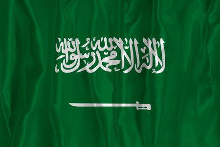 The flag of Saudi Arabia on a silk background is a great national symbol. Texture of fabrics The official state symbol of the countryの写真素材