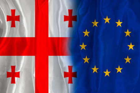 Georgian flag and EU flag. Flag of the country of Georgia and the European Union together. Conceptual image of Georgia and the European Union.の写真素材