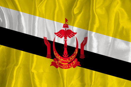 The flag of Brunei on a silk background is a great national symbol. Fabric texture The official state symbol of the country.の写真素材