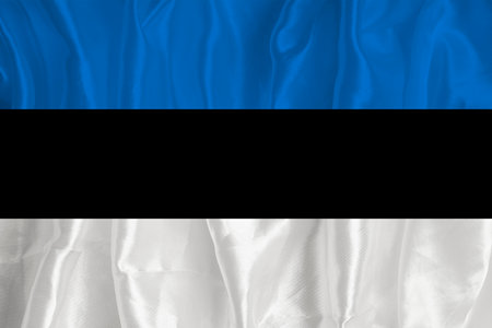 The flag of Estonia on a silk background is a great national symbol. Fabric texture The official state symbol of the country.の写真素材