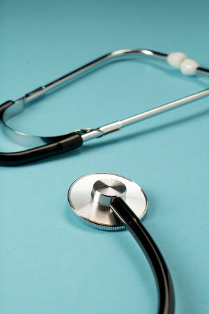 Medical instrument stethoscope in black on a blue background. medicine symbol.の写真素材