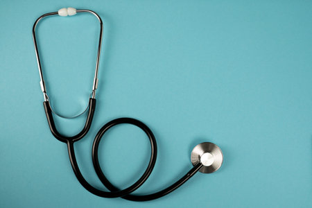 Medical instrument stethoscope in black on a blue background. medicine symbol.の写真素材
