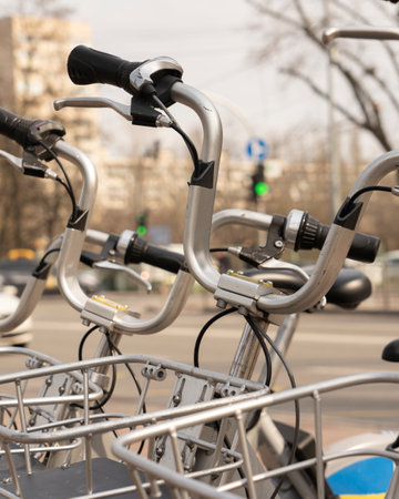 Modern rental electric bikes standing a row during charging on a bright day with a selective focus...