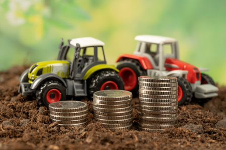 A small tractor in the garden with black soil. The concept of harvesting and making money on agricultureの写真素材