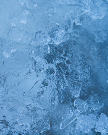 Icy winter background cracked grunge texture. Natural scratched ice on a skating rink as a texture...