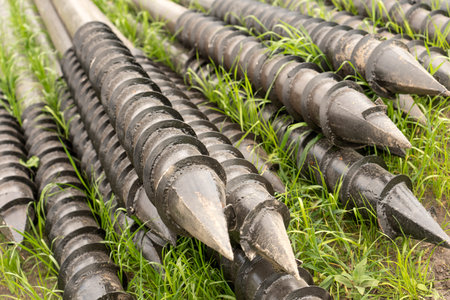 Screw piles for terrace foundations. Geo screws are steel round elements of an engineering structure. Industrial maintenance of metal tools for architectural construction work.の写真素材
