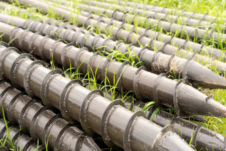 Screw piles for terrace foundations. Geo screws are steel round elements of an engineering structure. Industrial maintenance of metal tools for architectural construction work.の写真素材