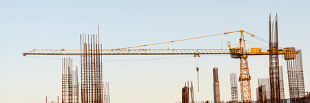tower cranes at construction site and city backgroundの写真素材