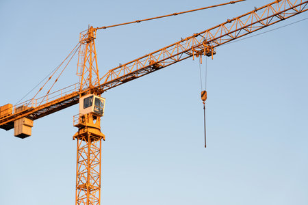 tower cranes at construction site and city backgroundの写真素材