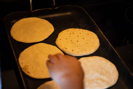 Traditional corn tortilla made by hand on stove from Guatemala and Central Americaの写真素材