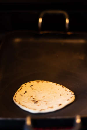 Traditional corn tortilla made by hand on stove from Guatemala and Central Americaの写真素材