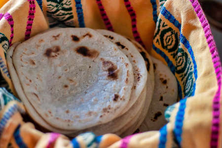 Traditional corn tortilla made by hand in a basket from Guatemala and Central Americaの写真素材