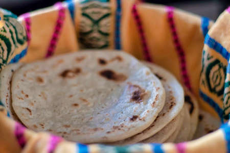 Traditional corn tortilla made by hand in a basket from Guatemala and Central Americaの写真素材