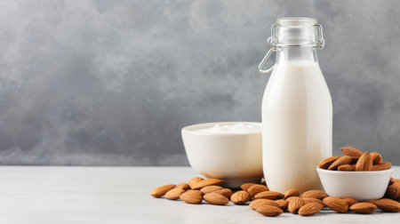 Almond milk in a glass bottle with almonds on a light background. Generative AIの素材