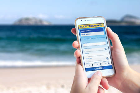 Flight and hotel searcher. Young woman in Ipanema beach using a white smartphone. Tourism booking...