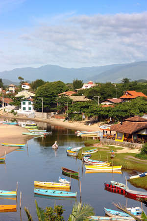 GUARDA DO EMBAU, SANTA CATARINA, BRAZIL - MARCH 20, 2009: Panoramic view of village next to the river. Many colorful boats are on the river near the mouth to the ocean. Destination in Latin America.のeditorial素材