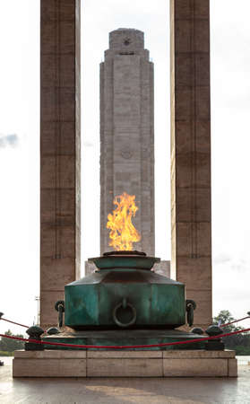 ROSARIO, ARGENTINA - MARCH 12, 2021: Eternal flame in the Triumphal Propylaea of ââthe Homeland and main tower. National Flag Memorial located at Rosario city, Argentina.のeditorial素材