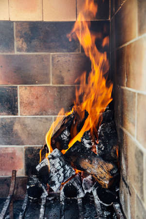Burning firewood. Making ready the embers for a barbecue. Fire in the fireplace of traditional argentinian grill. Roast doing.の写真素材