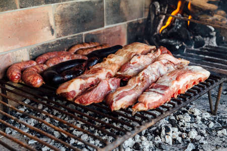 The meat of a traditional Argentine barbecue being roasted on a grill located in the patio of a...