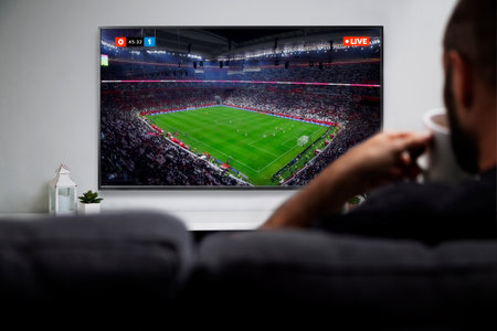 Man watching football match on smart TV. Live soccer transmission. ROSARIO, ARGENTINA - DECEMBER 18,...